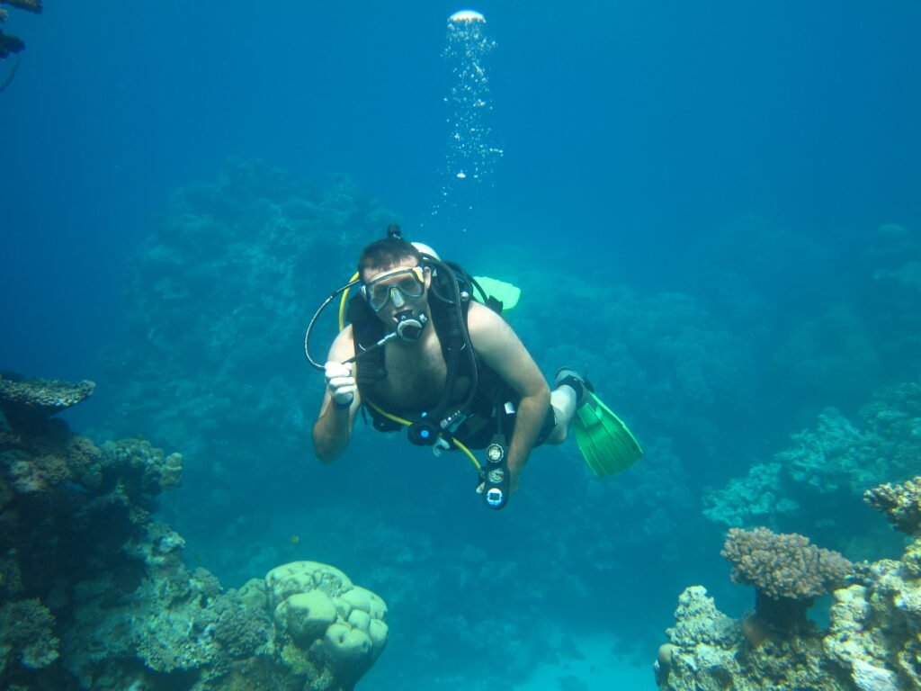 Chris, owner of Brown Box Storage, scuba diving on a coral reef