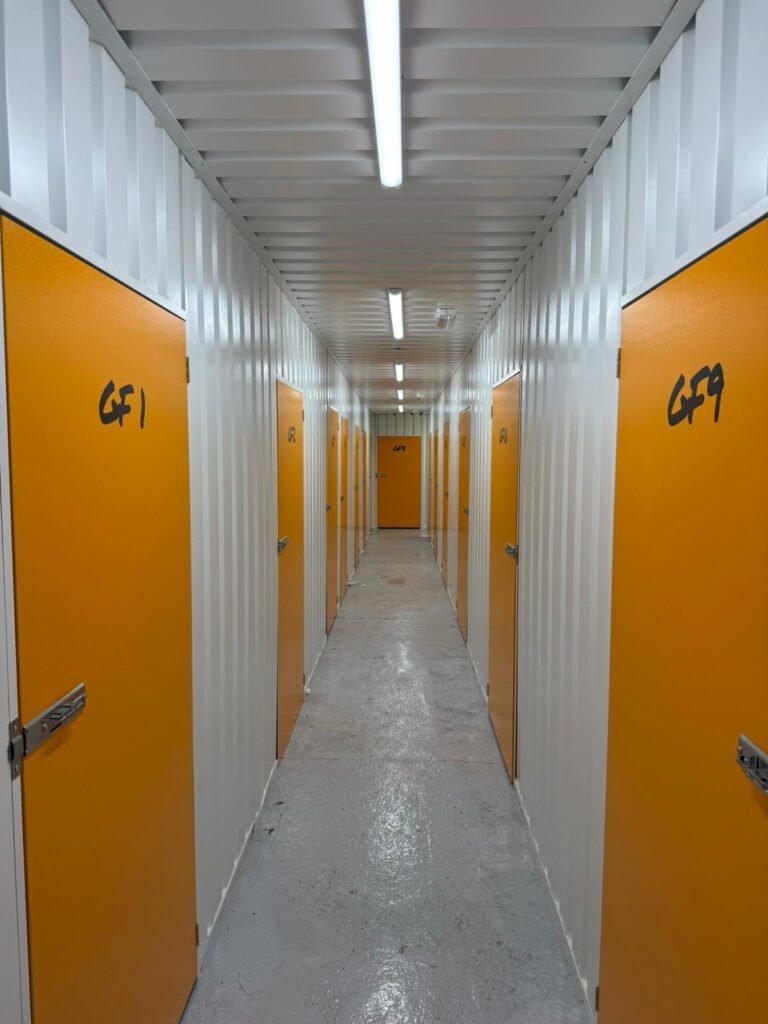 Bright corridor with orange doors at Brown Box Storage in Tamworth